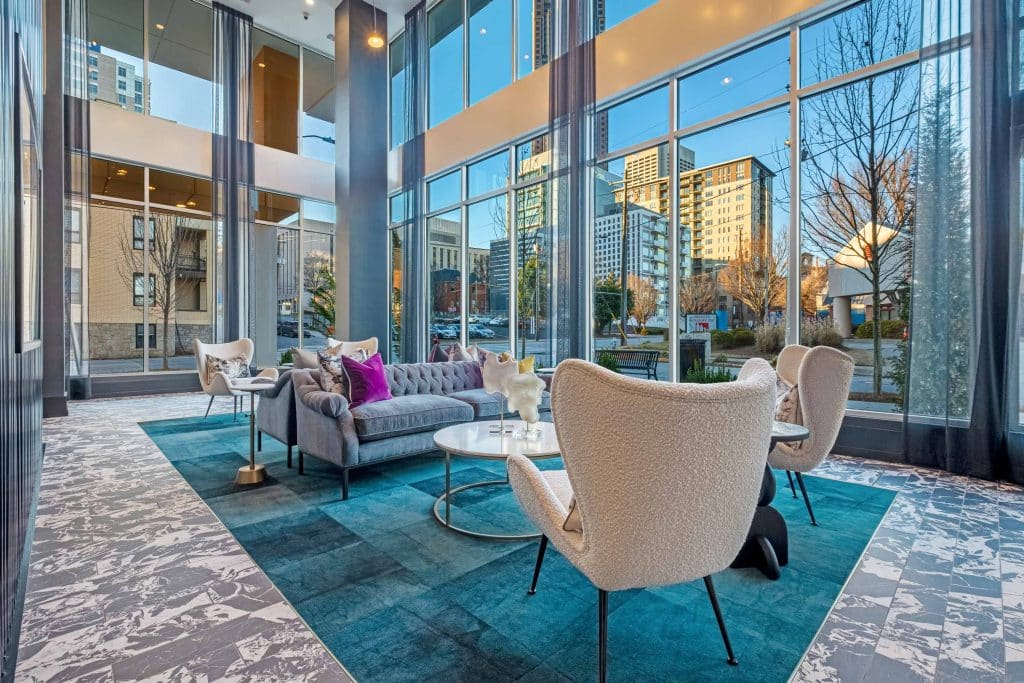 Furnished clubroom with chairs and floor to ceiling windows